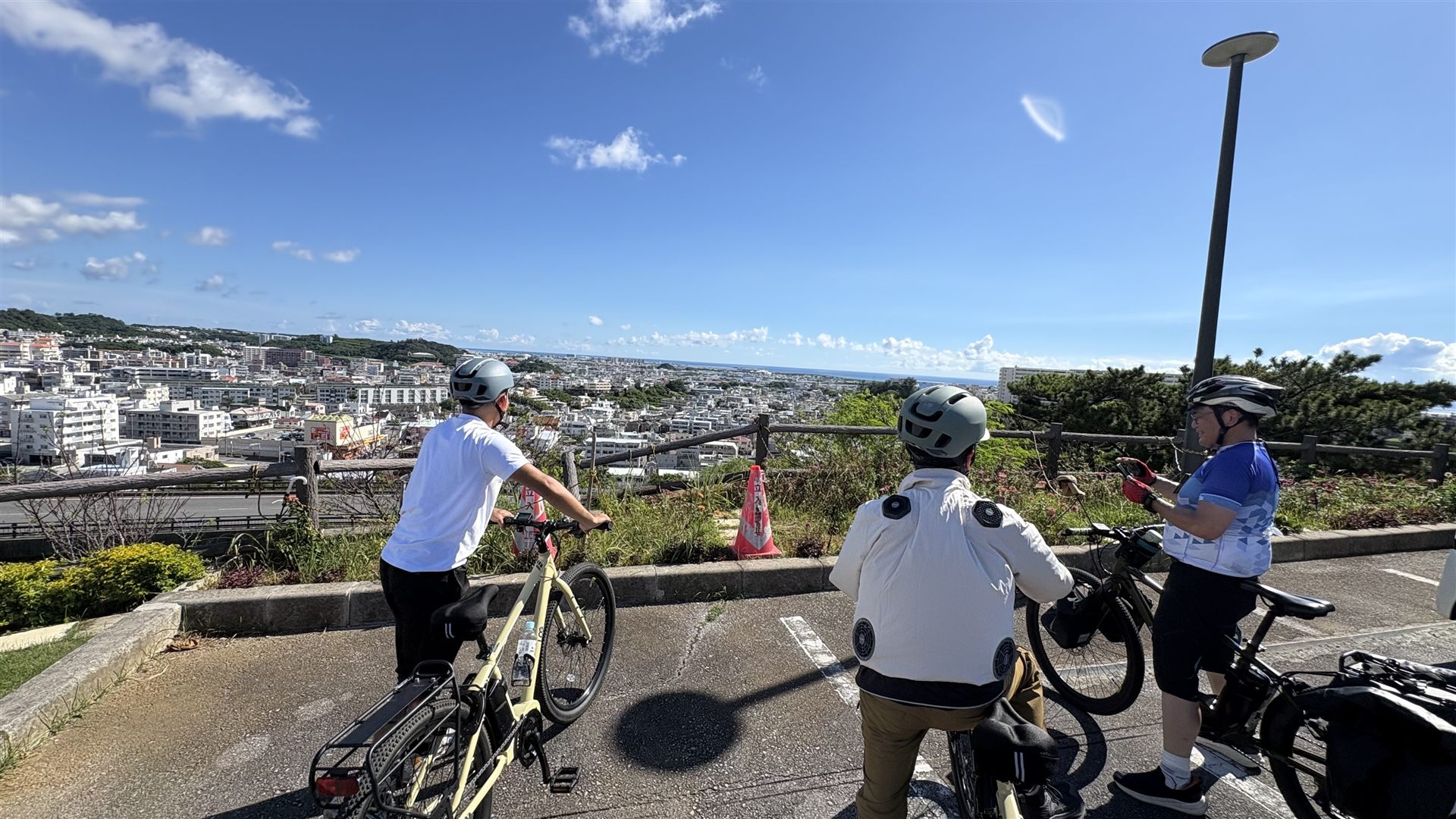 A cycling group looking over the town from a hilltop